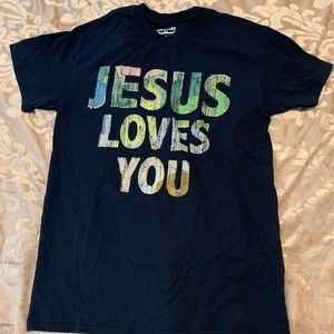 blue t-shirt with words “Jesus loves you” on it.
